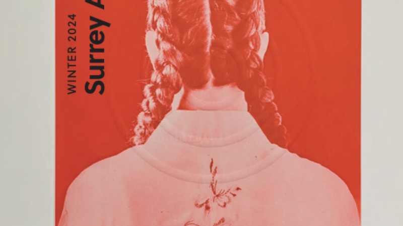 The cover of Surrey Art Gallery’s winter program guide shows an artwork of a person from the back with two thick braids parted in the middle. They have on a light jacket with a flower symbol in between their shoulder blades. The image is monochromatic red, a stark and vibrant red. There are three white circles overlaid on the figure. Text reads: “Winter 2024 Surrey Art Gallery. Engaging Contemporary Art.”