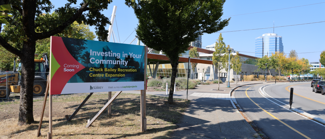 sign in front of recreation centre that reads "coming soon investing in your community: chuck bailey recreation centre expansion"