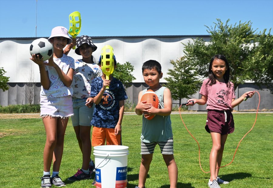 five children pose with sporting equipment