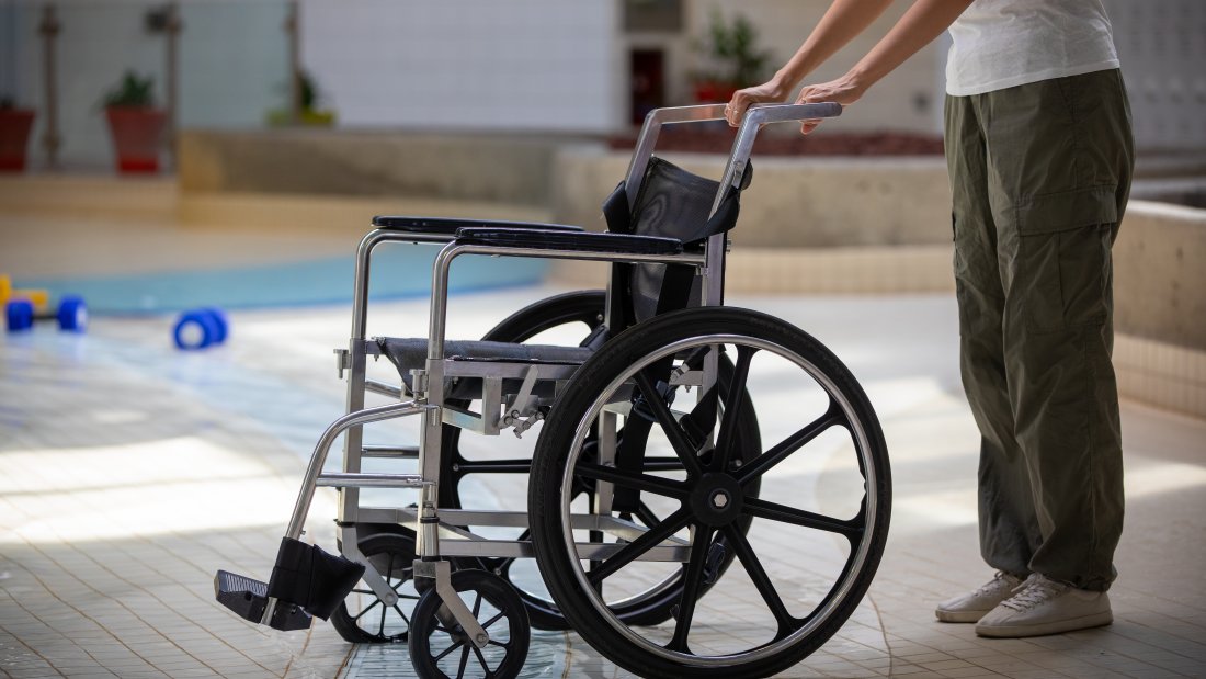 A wheelchair beside a pool
