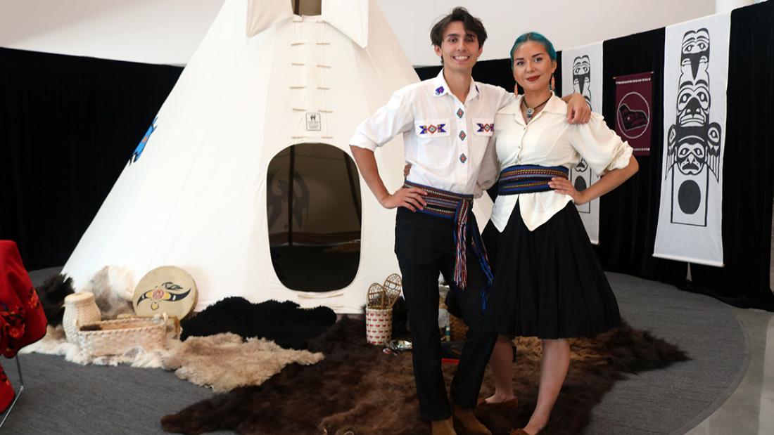 Couple stands in front of a Tee Pee