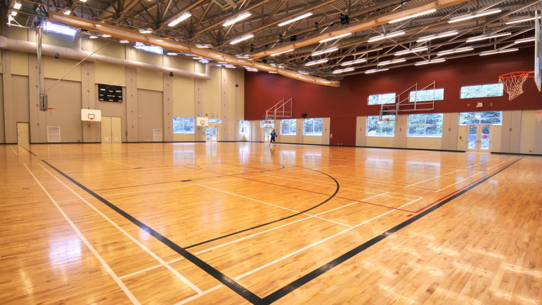 An empty gymnasium with basketball hoops