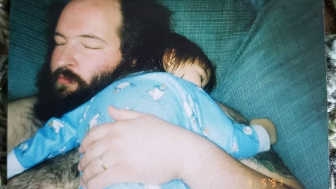 WWF wrestler John Tenta hugging his child