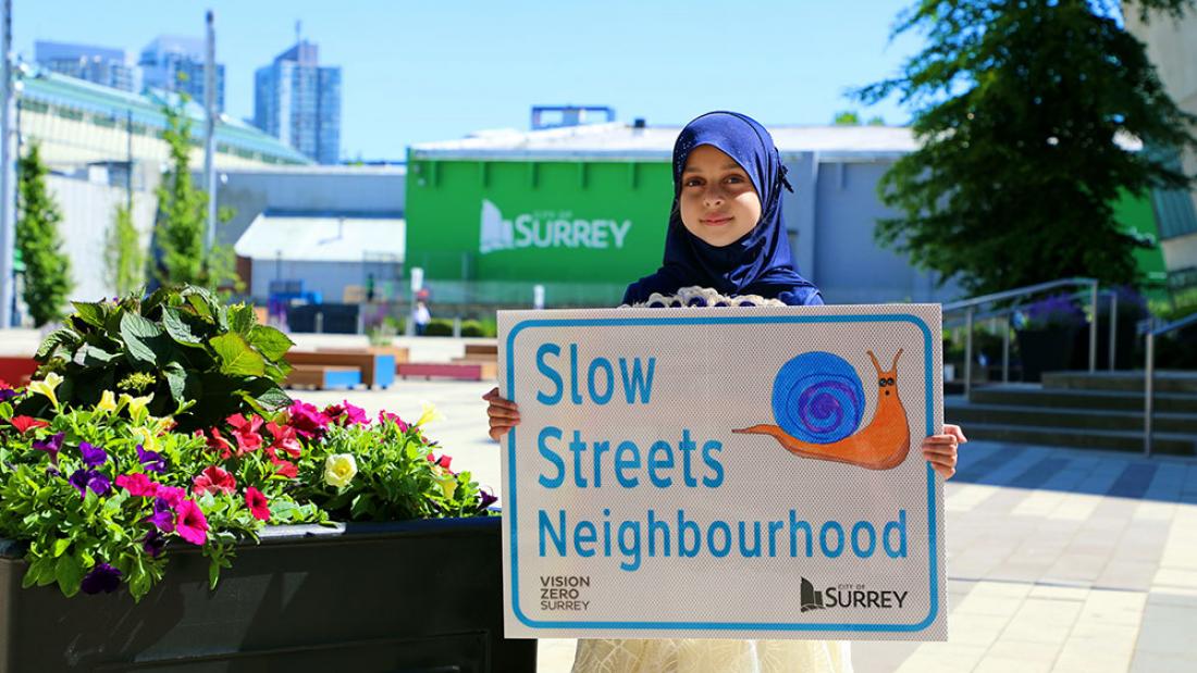 Slow Streets Winner Atikah holding her design