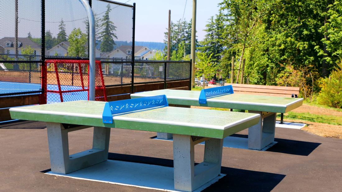 Green and blue table tennis outdoors