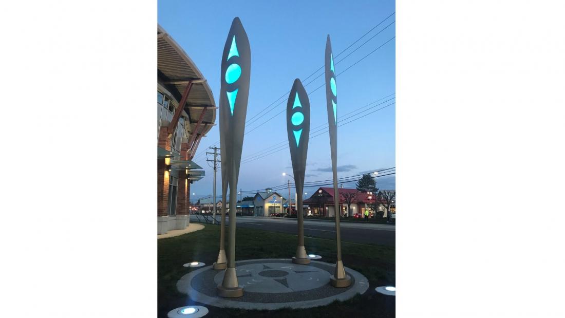 Four large indigenous paddles with blue LED lights