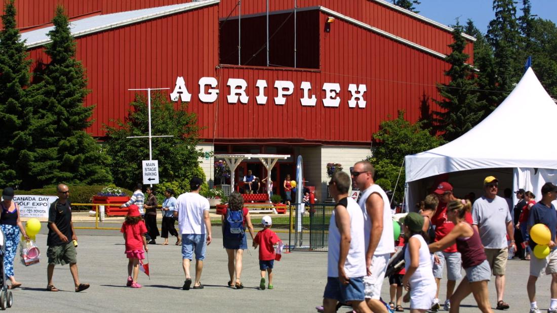 Large red barn with a crowd in front