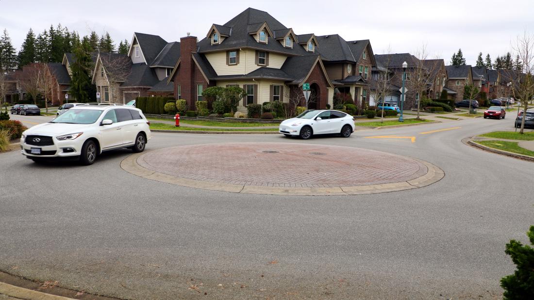 traffic circle with no vegetation with vehicles around it