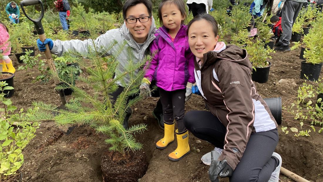 A family planting a tree.