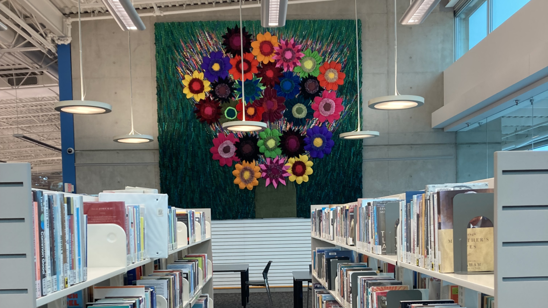 Photo of Flower Power by Sola Fiedler: Colourful tapestry depicting 3D flowers made from repurposed and recycled materials