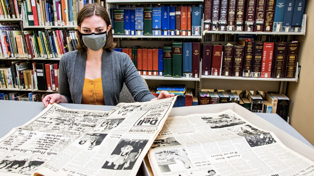 A researcher looking at old newspapers