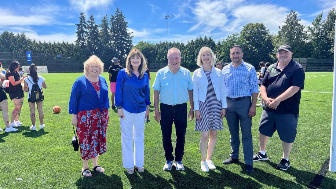 Mayor & Council standing on artificial turf field