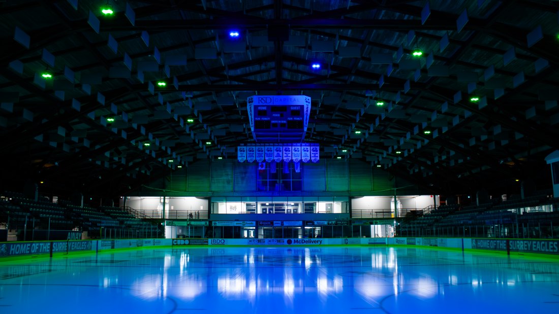 An ice rink under blue lights.
