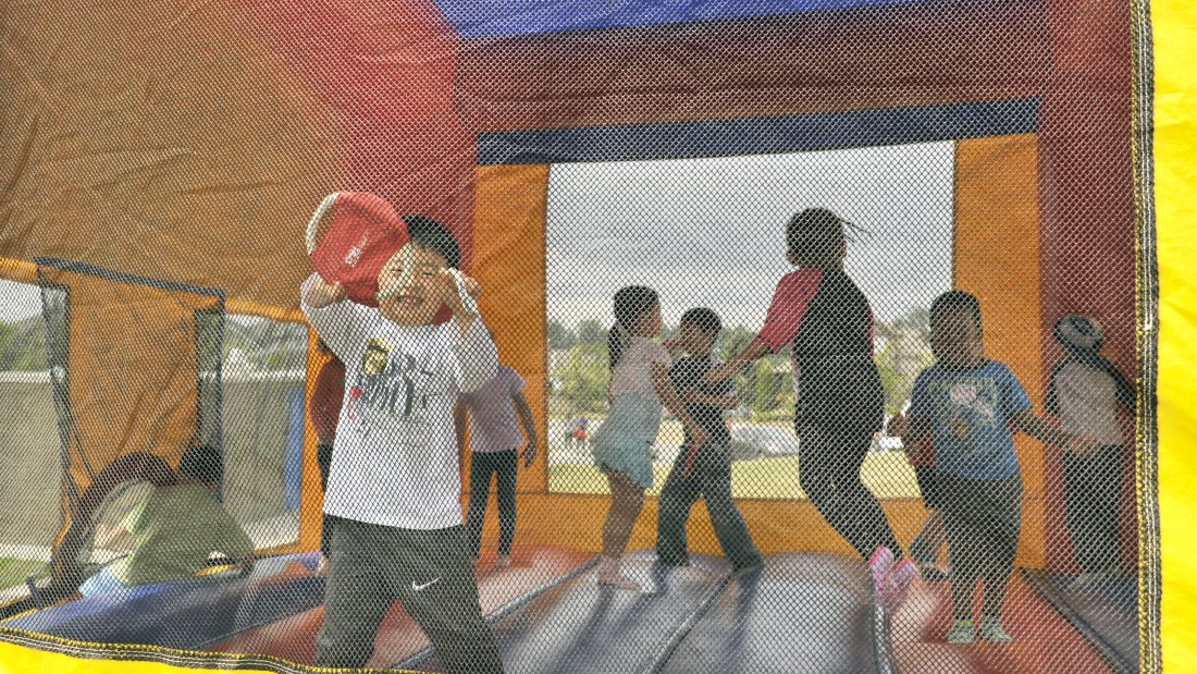 Children bouncing in a bouncy castle.