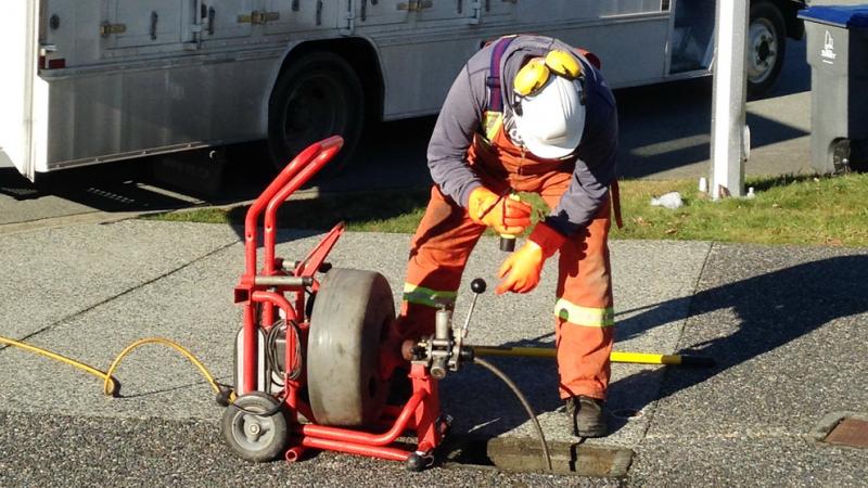 person doing maintenance on sanitary sewer