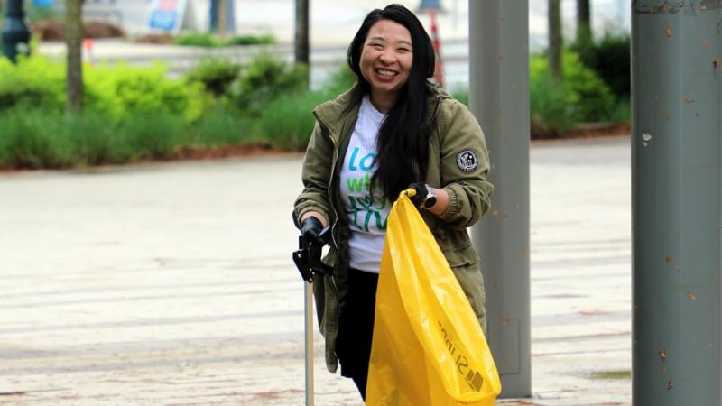 Neighbourhood cleanup volunteer in a Love Where You Live T-Shirt.