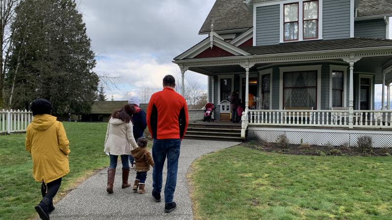 family approaches historic stewart farmhouse