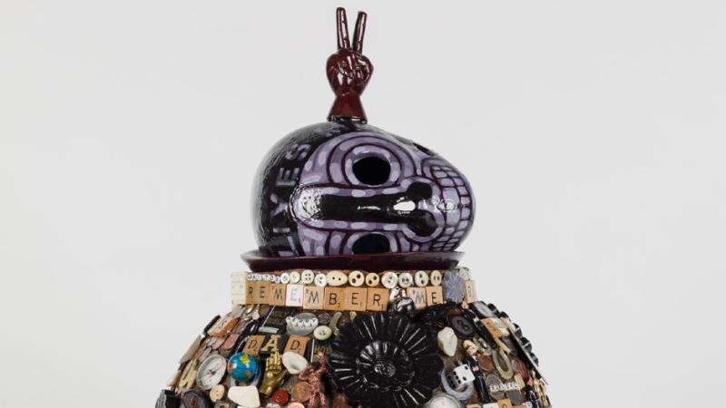 Jan Wade's Memory Jug is a large ceramic vessel covered in memorabilia related to the author's life and Black American culture.