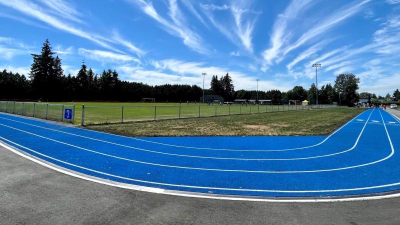 blue walking track and artificial turf field