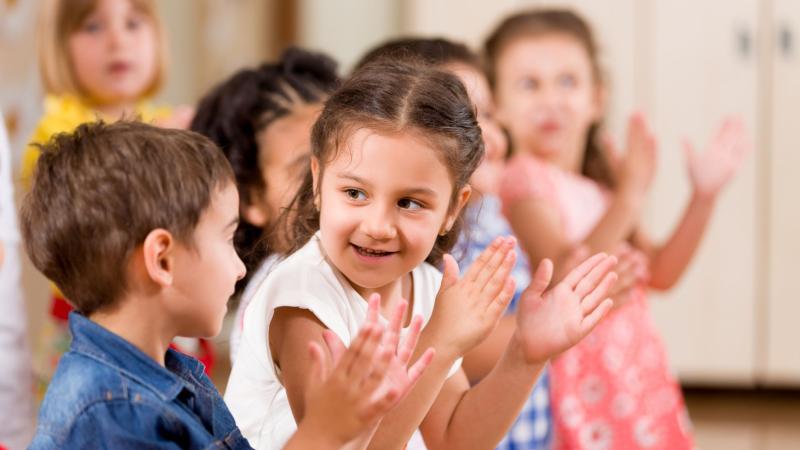 Preschool kids clapping their hands.