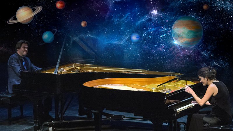 The Bergmann Duo play the piano surrounded by planets