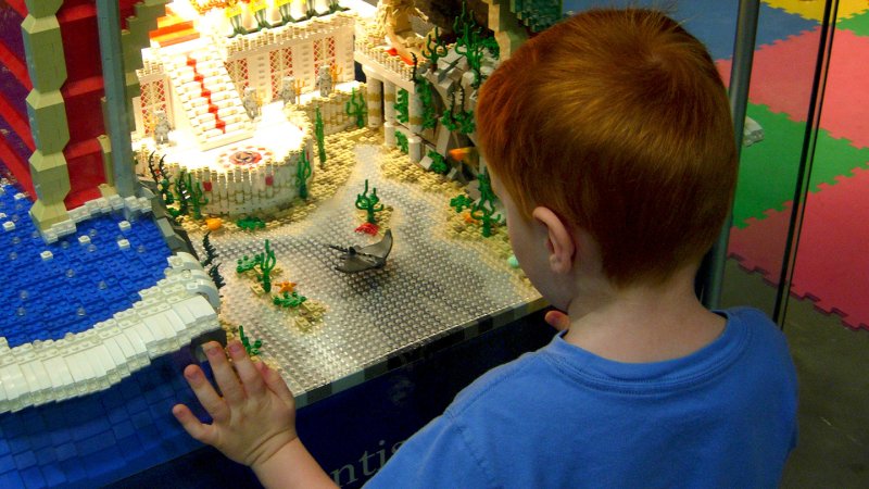 A boy looking at a lego diplay