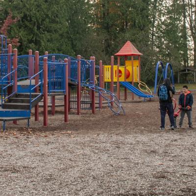 a blue playground with people standing around