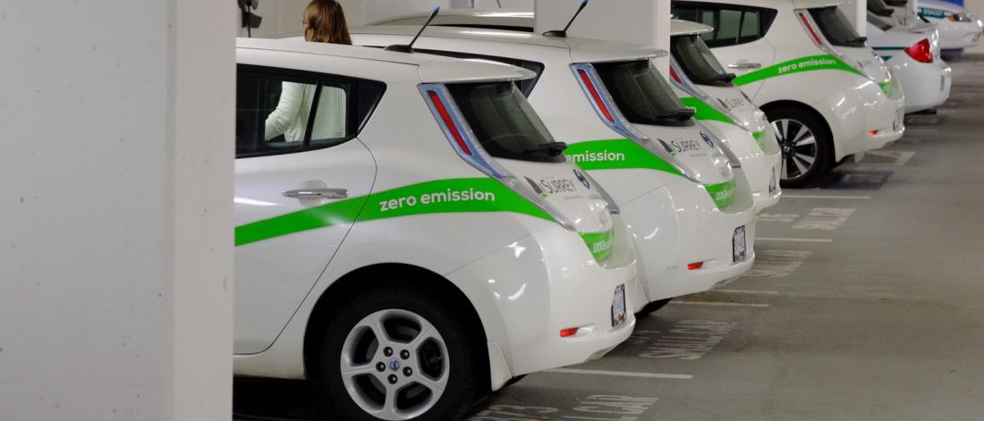 row of parked electric cars in parkade