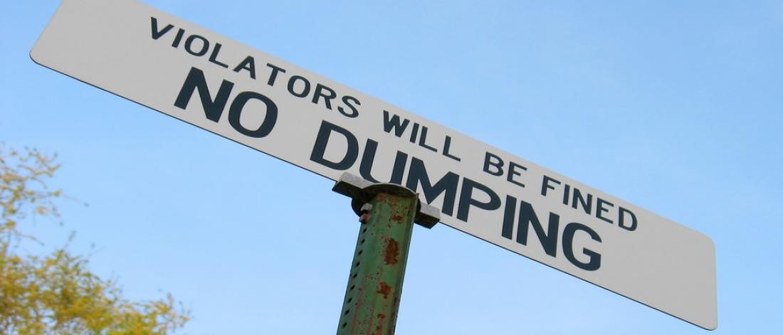 No Dumping street sign that reads "Violators will be fined"