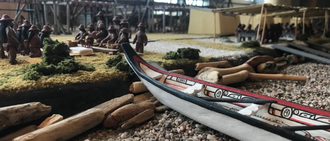 A canoe is featured as part of a diorama.