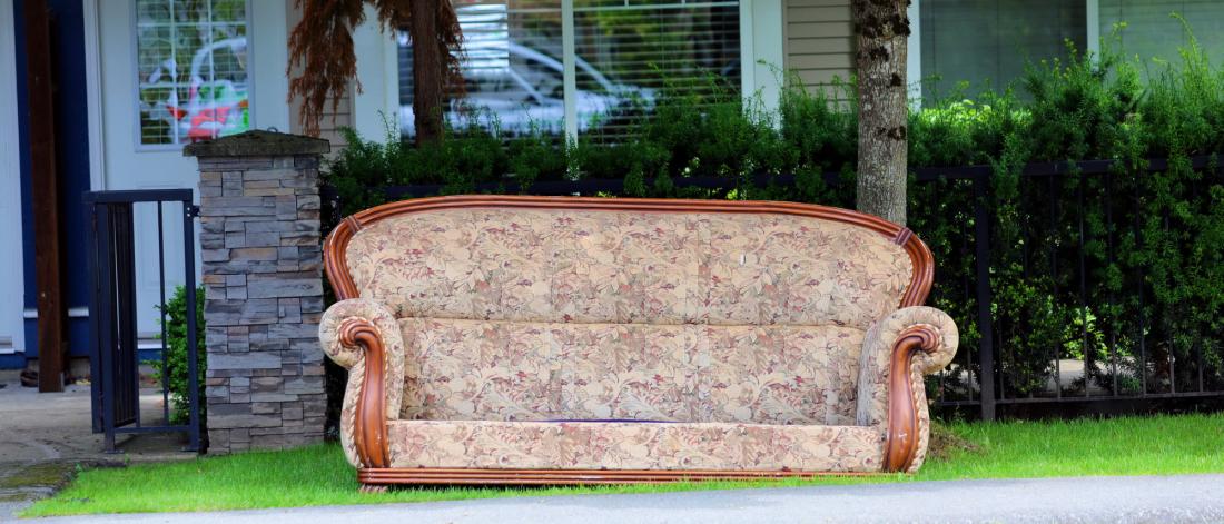 Vintage couch on the side of the curb