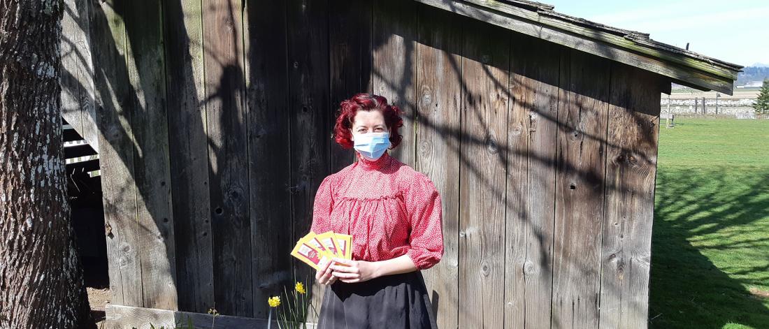Woman Standing in Front of Shed while wearing a Mask
