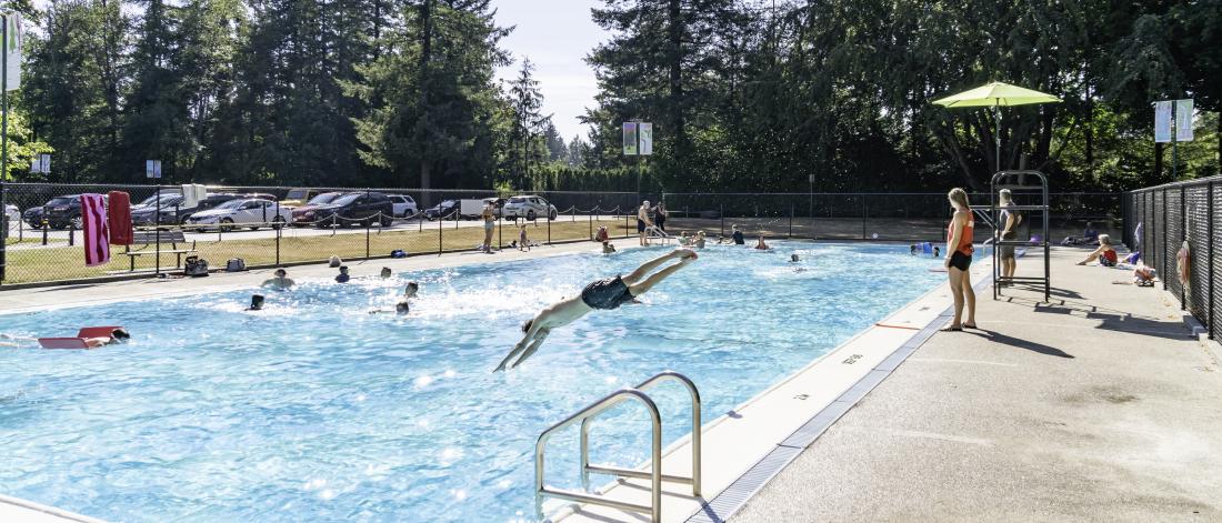 People enjoying free swimming at outdoor pools.
