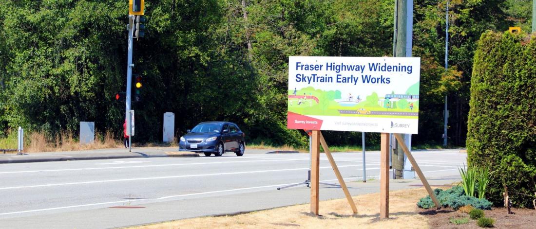 A road sign that reads "Fraser Highway Widening: SkyTrain Early Works"