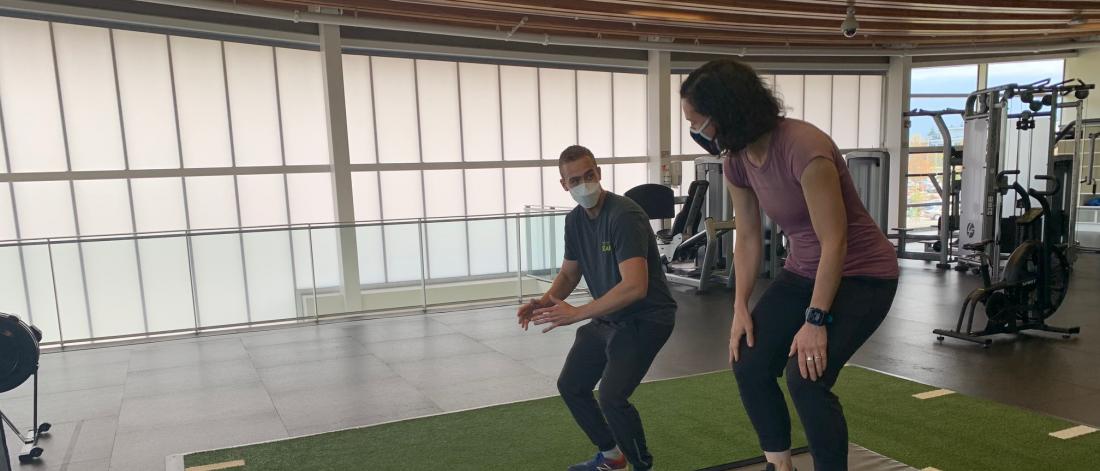 Personal trainer showing a woman how to work out.