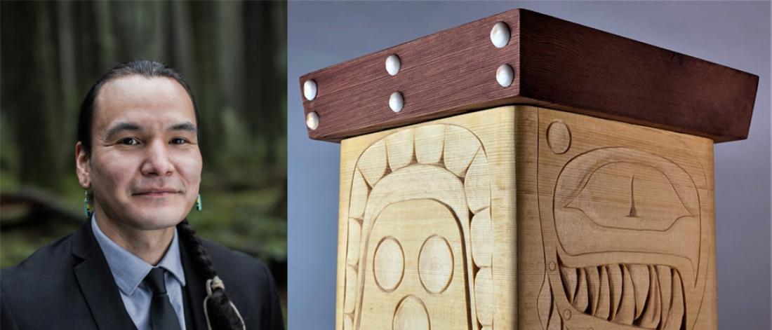 Photograph of artist Alexander Erickson next to one of his wooden bentwood box carvings.