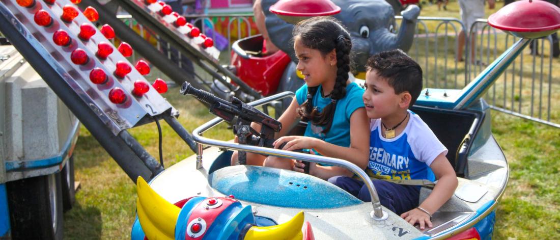 Two children on an amusement park ride