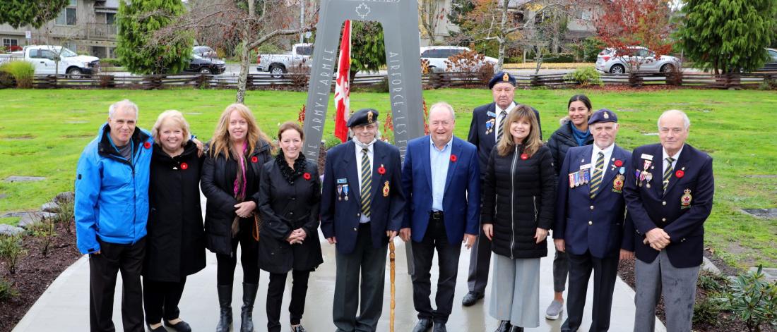 Mayor and Council in front of a new cenotaph outdoors