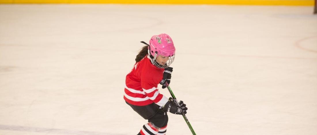 Girl playing hockey.