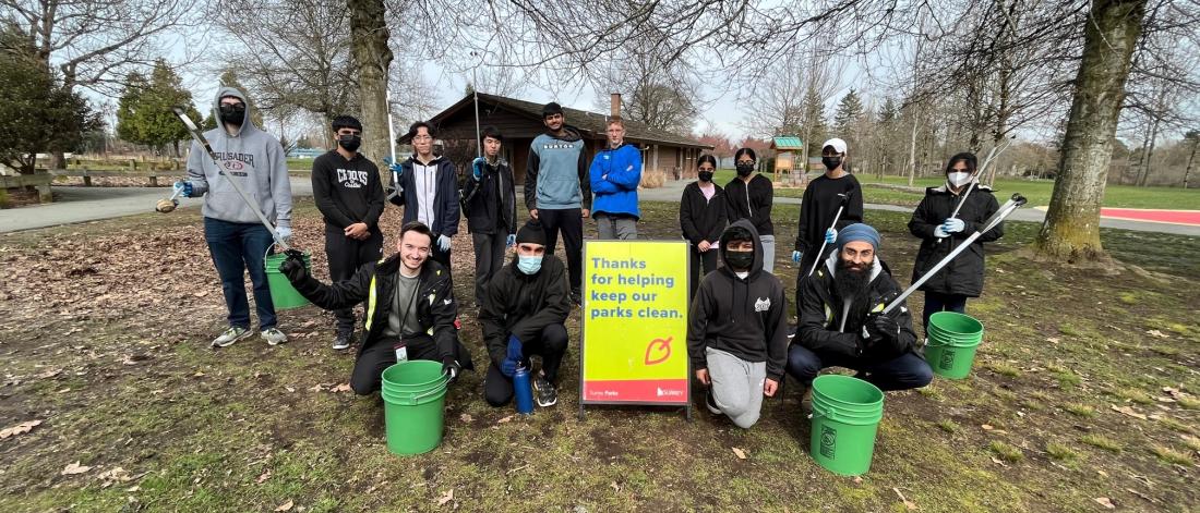 Youth with garbage pickers and buckets at a clean up event