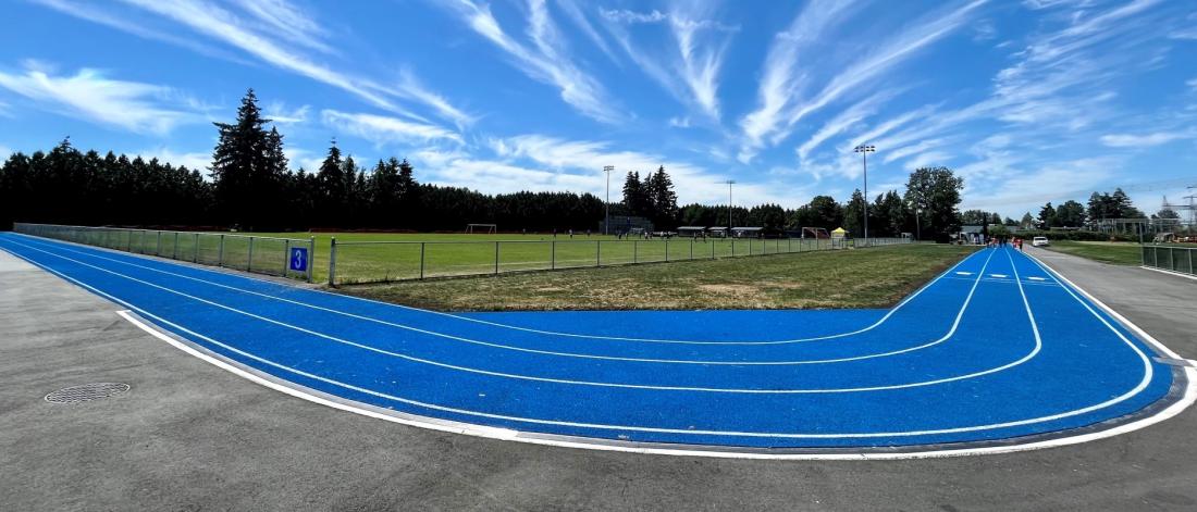 blue walking track and artificial turf field