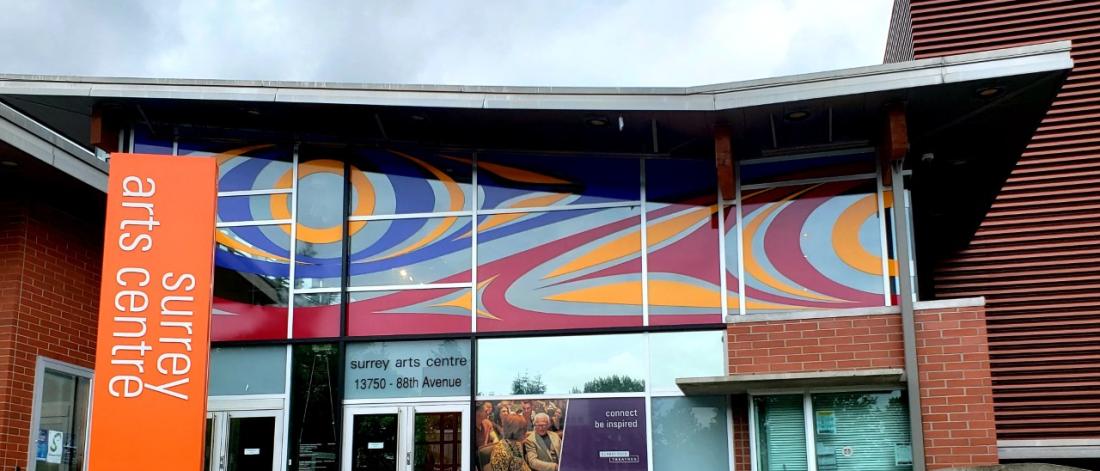 Entrance to Surrey Art Gallery and Surrey Arts Centre showing a colourful vinyl window mural.