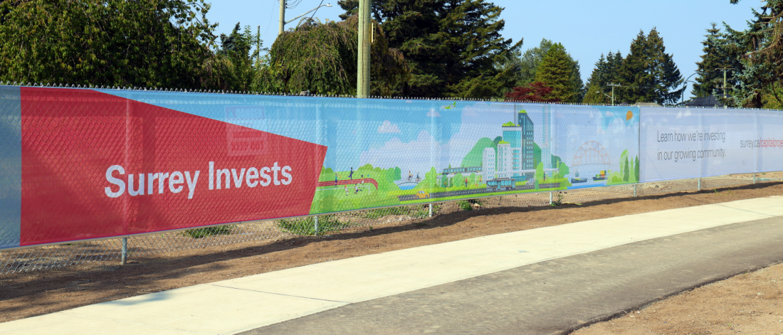 fence scrim with Surrey Invests text
