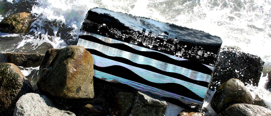 Mixed media artwork of rocks splashed by waves, a cellphone case lying on rocks with a cityscape image on it
