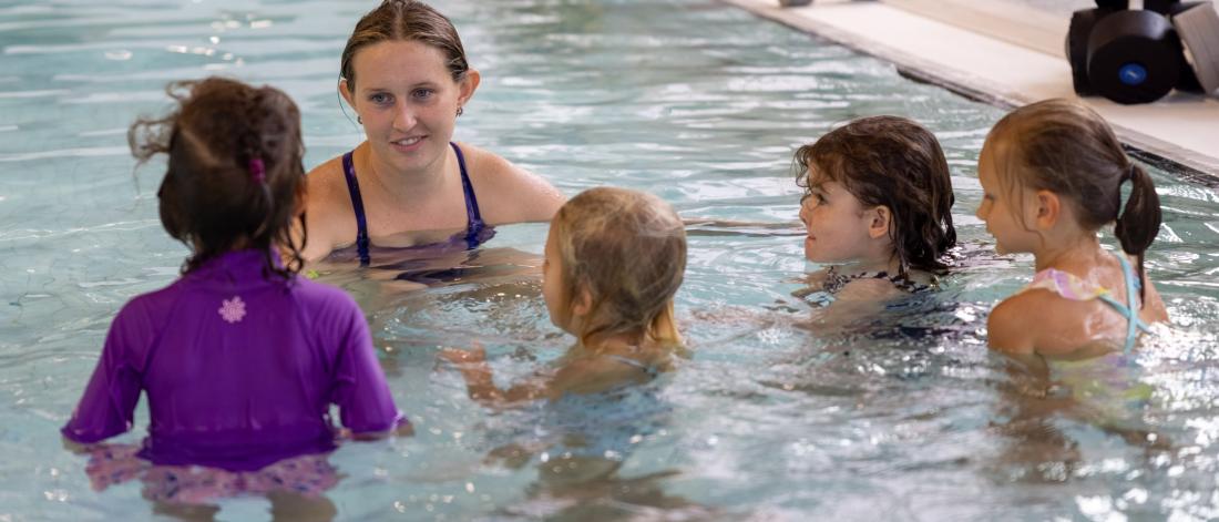 swim instructor in water with kids