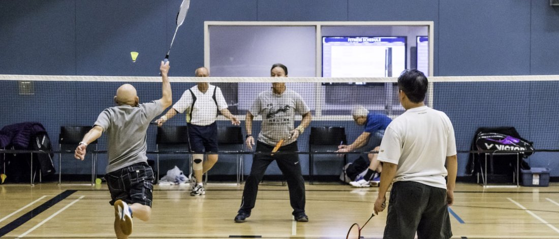 four men playing badminton