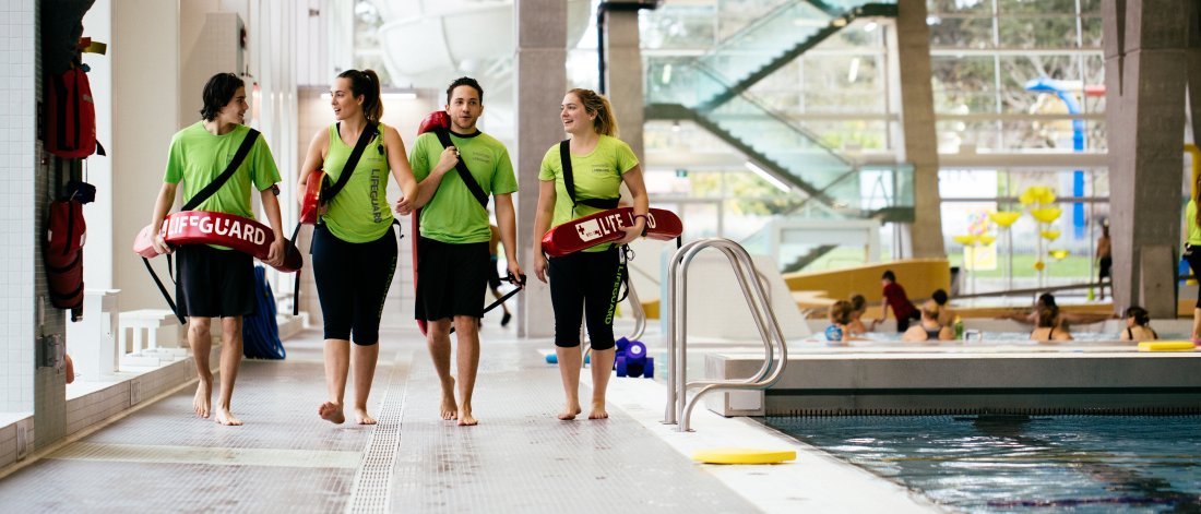 Lifeguards walking on the pool deck.