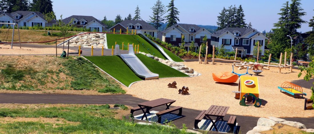 a park with slides and picnic tables