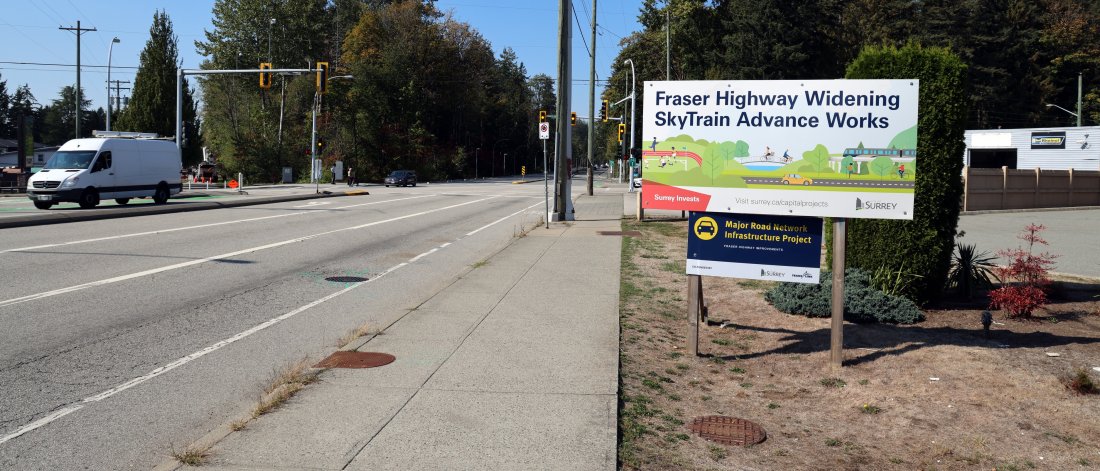 A road sign that reads "Fraser Highway Widening: SkyTrain Advance Works"