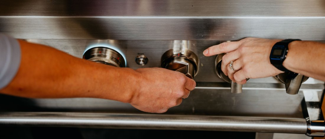 Picture of person turning off stove